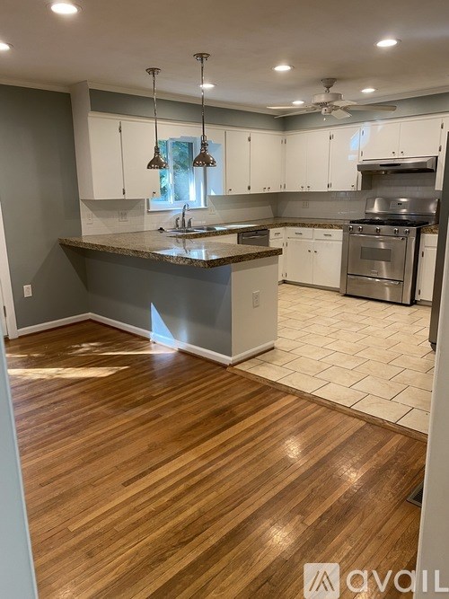 A kitchen with wooden floors and a center island.