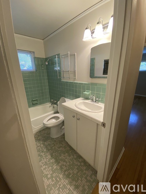 A bathroom with a toilet, sink, and a bathtub.