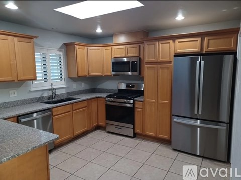 A kitchen with wooden cabinets and stainless steel appliances.