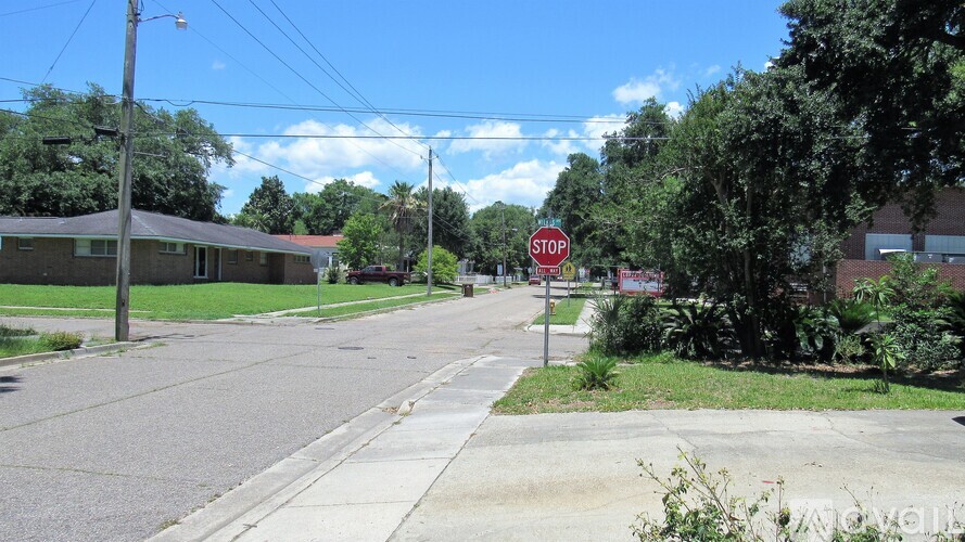 A stop sign is on the side of a road.