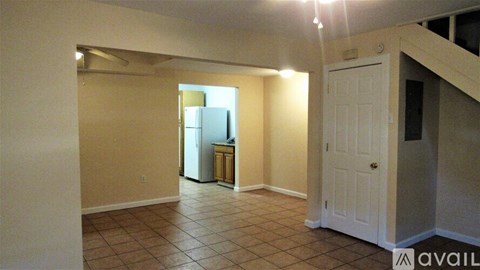 A kitchen area with a refrigerator and a cabinet.