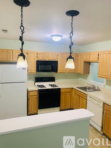A kitchen with wooden cabinets and a white refrigerator.