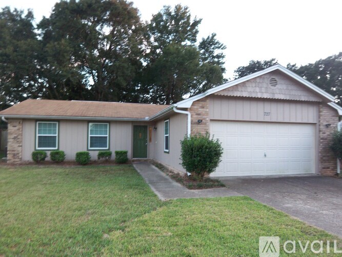 A house with a garage and a driveway in front.