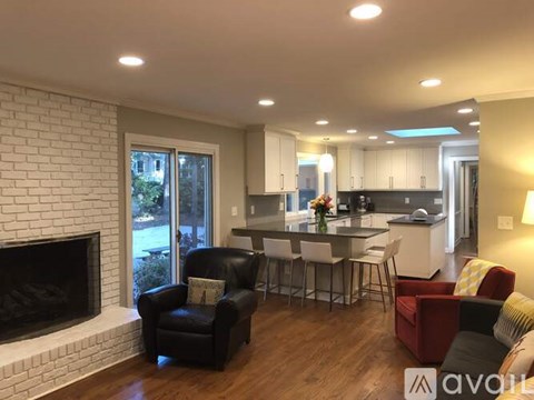 A living room with a fireplace and a dining table set up.