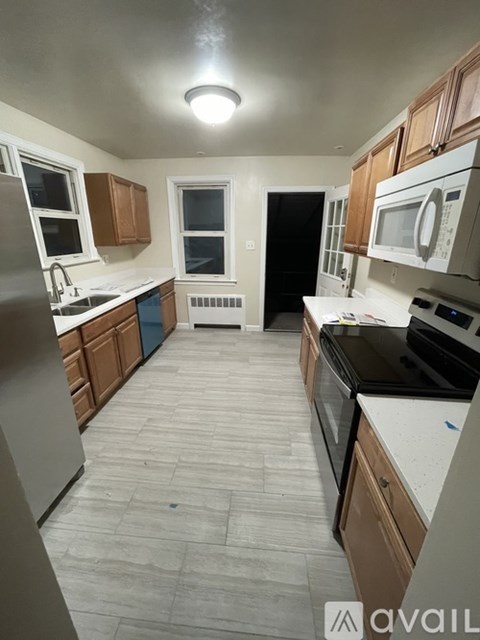 A kitchen with wooden cabinets and a black oven.