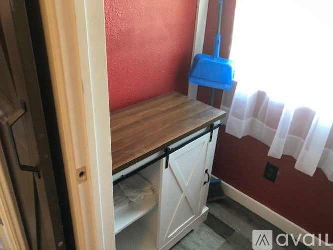 A kitchen with red walls and a wooden counter.