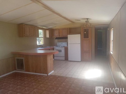 A kitchen with wooden cabinets and a white refrigerator.