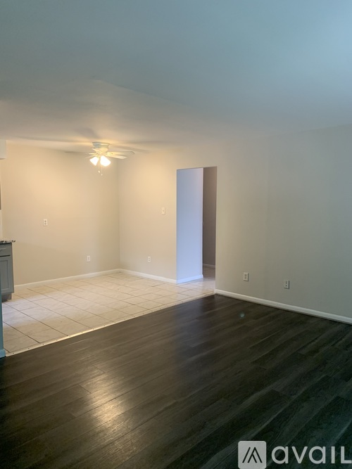 A room with wooden floors and a ceiling fan.
