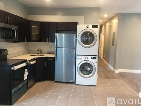 A kitchen with a black oven and a black microwave.