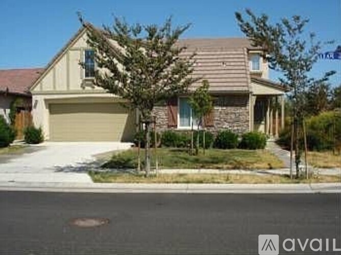 A house with a garage and a driveway in front.