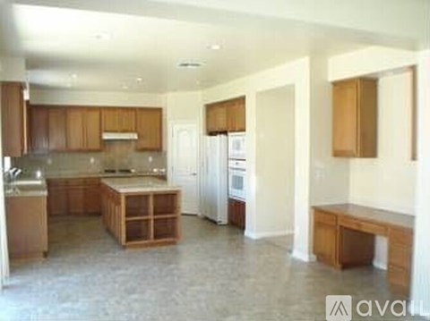 A kitchen with wooden cabinets and a white refrigerator.