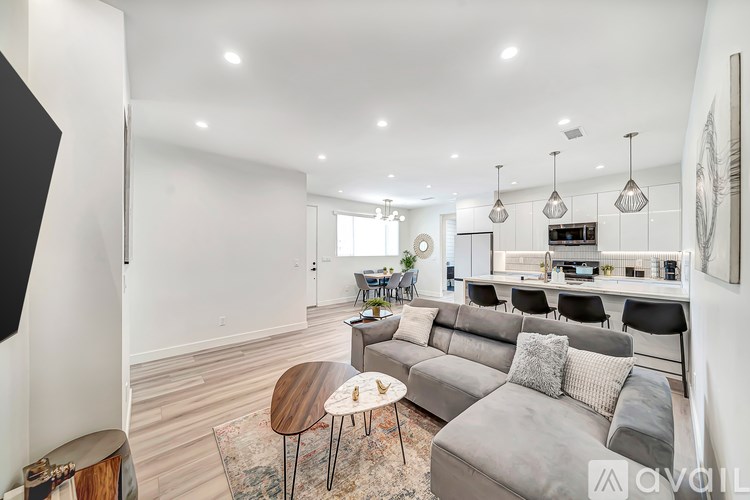 A modern living room with a grey sofa and a wooden coffee table.