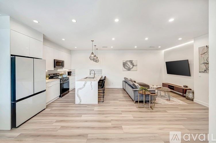 A modern kitchen with a dining area and a living room.
