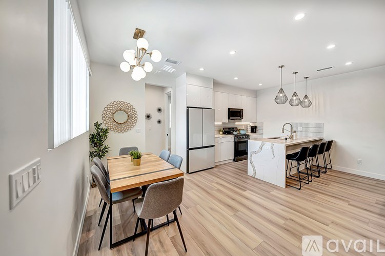 A modern kitchen with a dining table and chairs.
