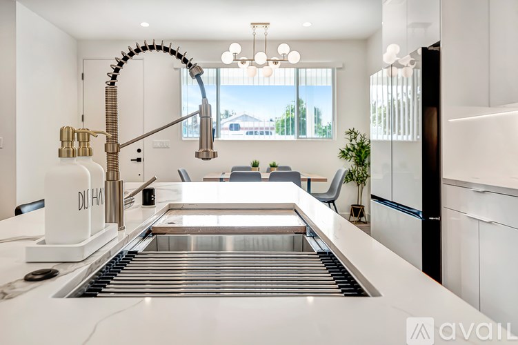 A modern kitchen with a large island and a sink.