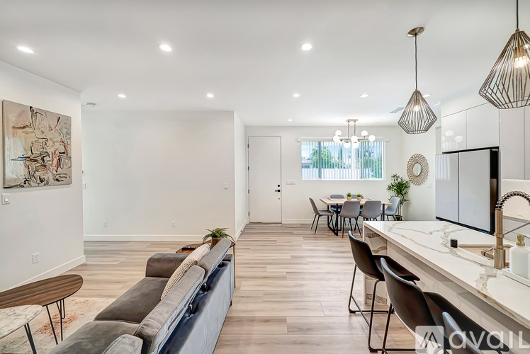 A modern living room with a grey sofa and a wooden table.