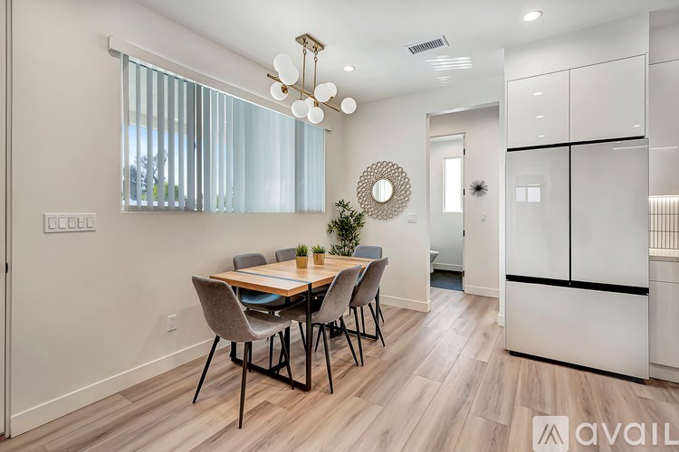 A dining room with a table set for four.