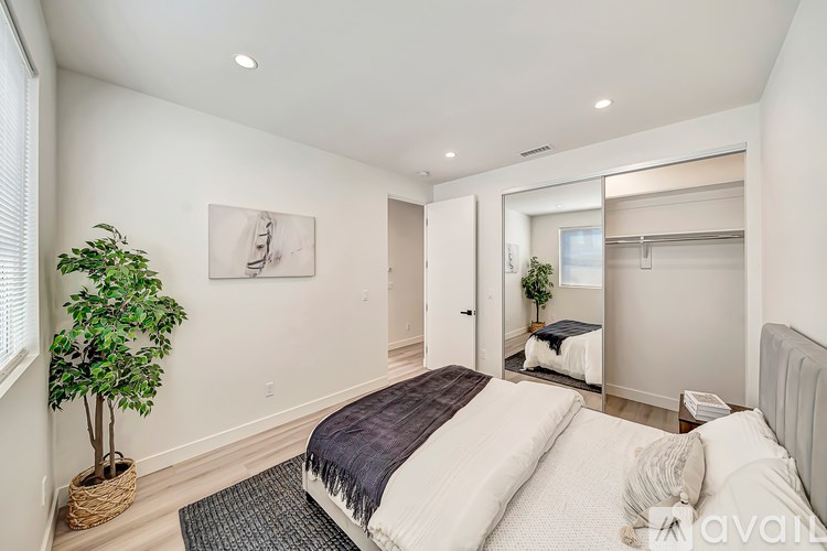 A bedroom with a large bed and a mirror on the wall.