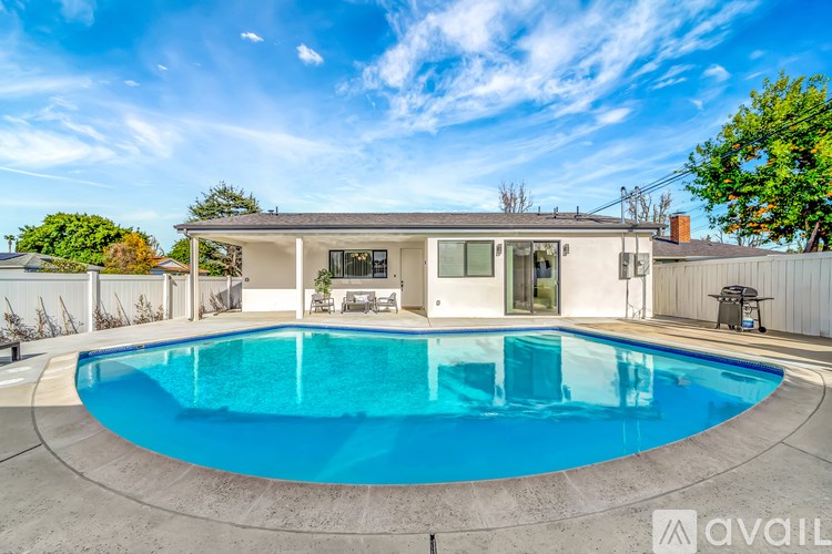 A house with a pool in the backyard.