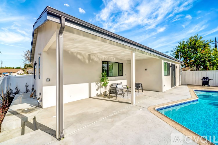 A modern house with a pool in the backyard.