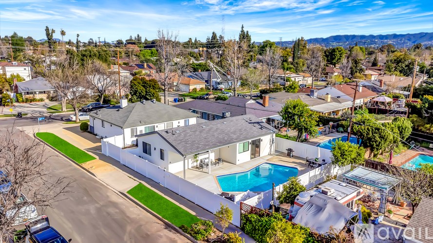 A large house with a pool in the backyard.