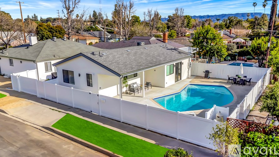 A house with a pool in the backyard.
