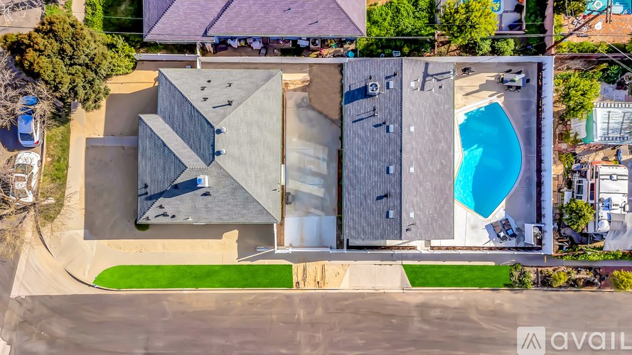 A modern house with a swimming pool and a car parked in the driveway.