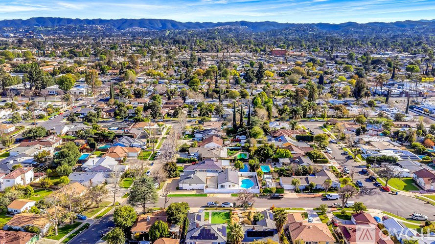 A bird's eye view of a residential area with houses and trees.