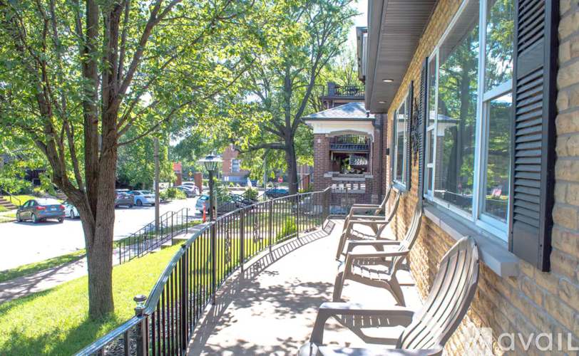 A row of wooden benches are on a patio.