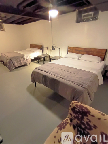 A bedroom with two beds and a leopard print chair.