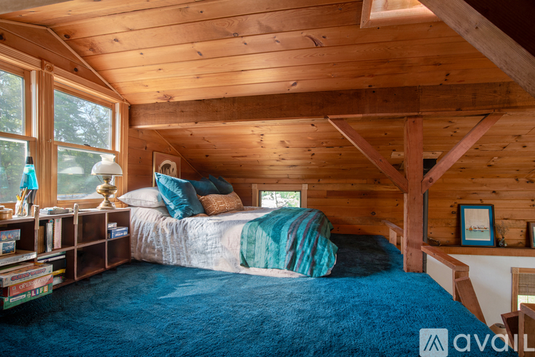 A bedroom with a bed and a window.