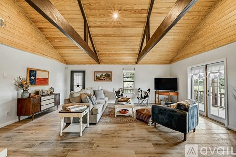A living room with wooden floors and furniture.
