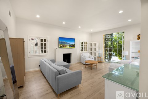 A modern living room with a grey sofa and a fireplace.