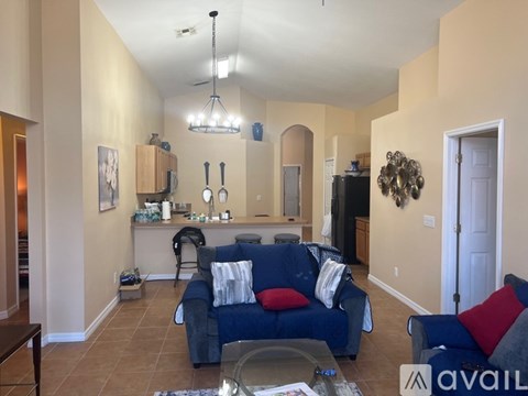 A living room with a blue couch and a coffee table.