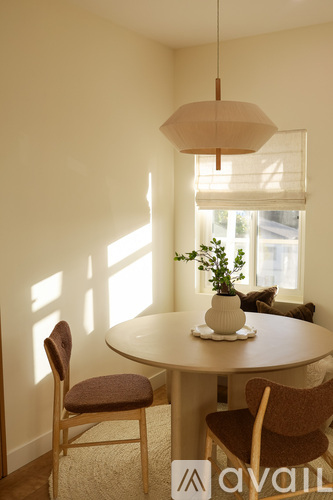 A table with two chairs and a plant on it.