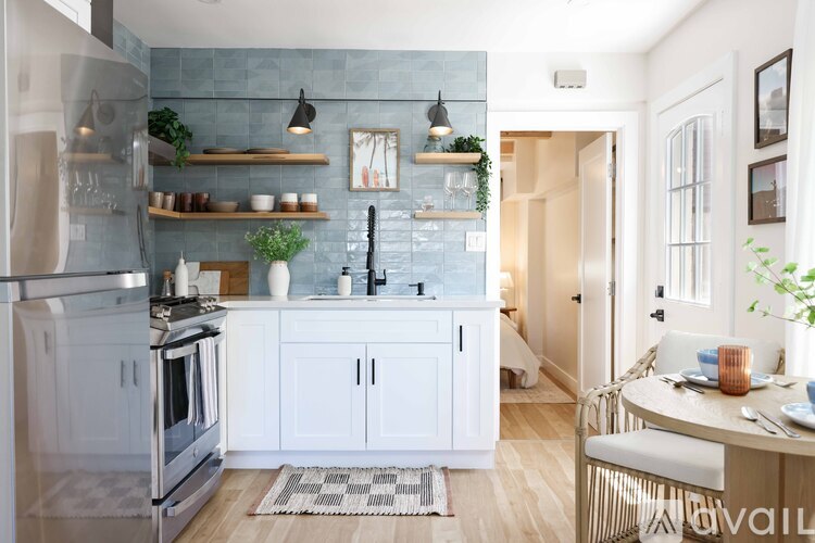 A kitchen with a stove top oven and a refrigerator.