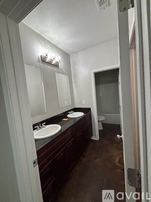 A bathroom with a vanity and a toilet.
