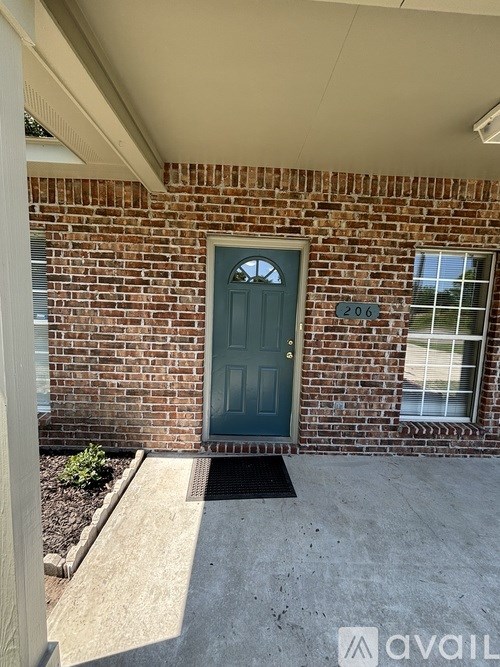 A house with a green door and a number 206 on the wall.