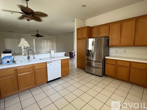 A kitchen with wooden cabinets and a refrigerator.