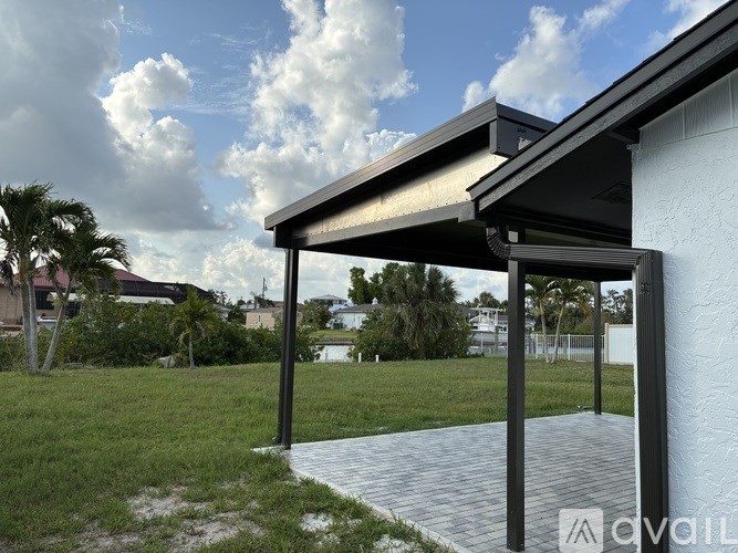 A covered walkway leads to a white building.