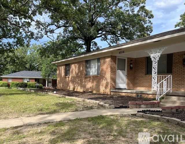 A brick house with a white door and a porch.
