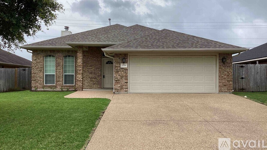 A house with a grey roof and a garage door.