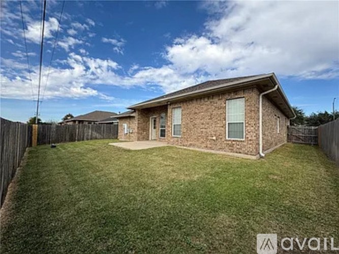 A house with a fenced backyard is for sale.