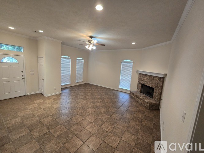 A living room with a fireplace and a tiled floor.