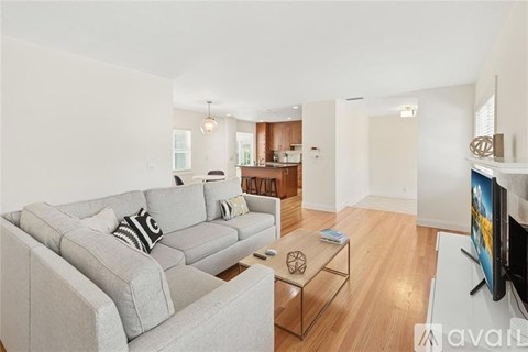 A living room with a grey couch and a coffee table.