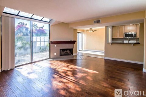 A living room with a fireplace and sliding glass doors.