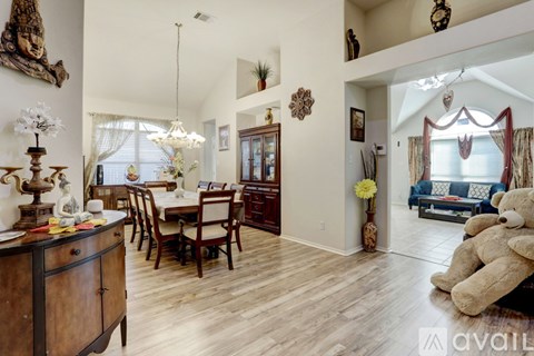 A living room with a dining table and chairs.