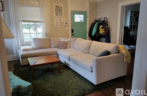 A living room with a white couch and a coffee table.