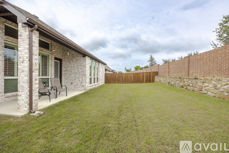 A house with a patio and a stone wall.