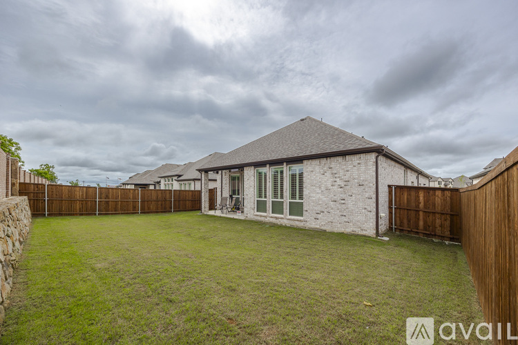 A house with a stone exterior and a wooden fence.